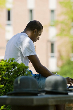 photo of a student sitting outside on campus
