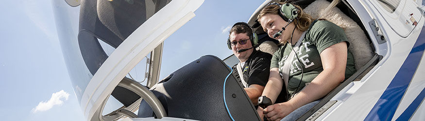 photo of a student and instructor in an airplane