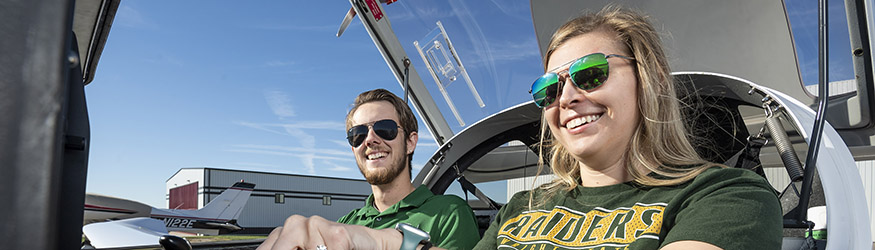 photo of a student and instructor in a plane