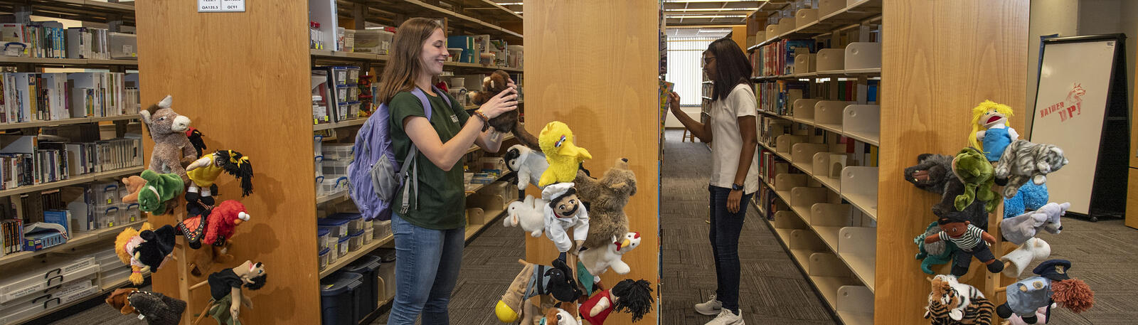 photo of students looking at materials in the library
