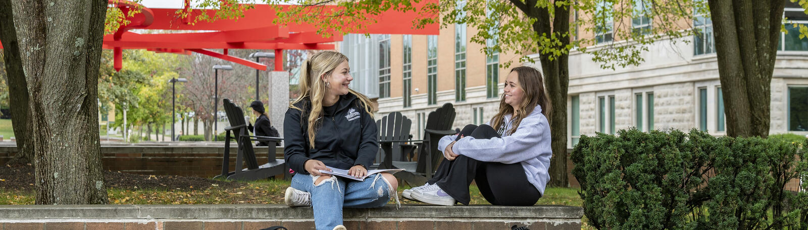 photo of students sitting outside on campus