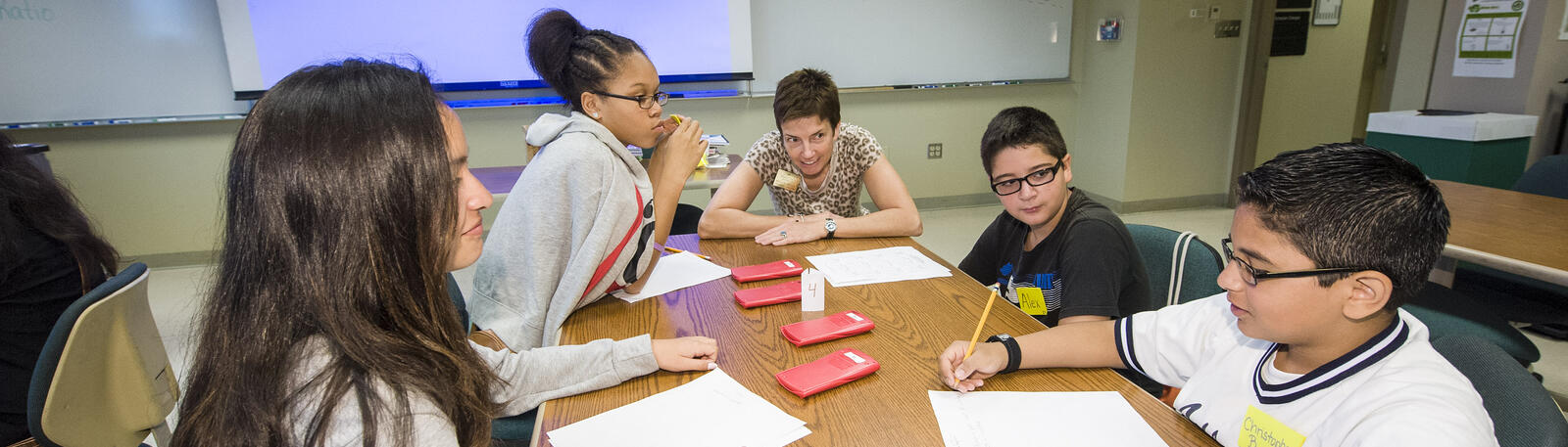 photo of a teacher and students in a classroom