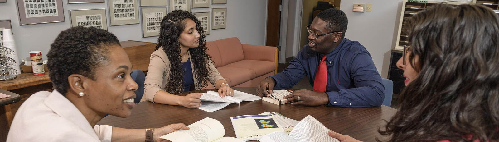 photo of students sitting at a table studying 