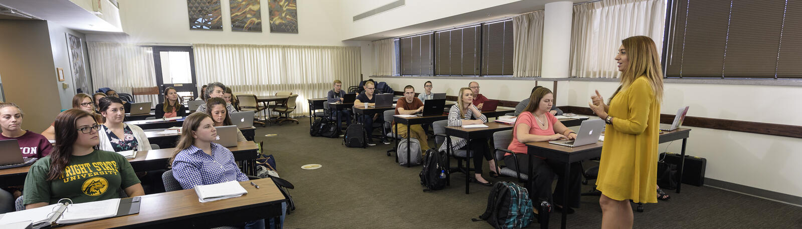 photo of students and a professor in a classroom