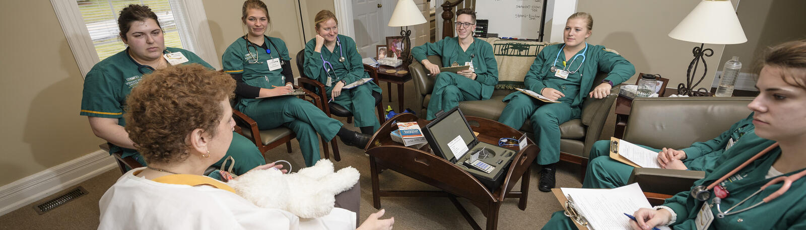 photo of nursing students and an instructor in a lab