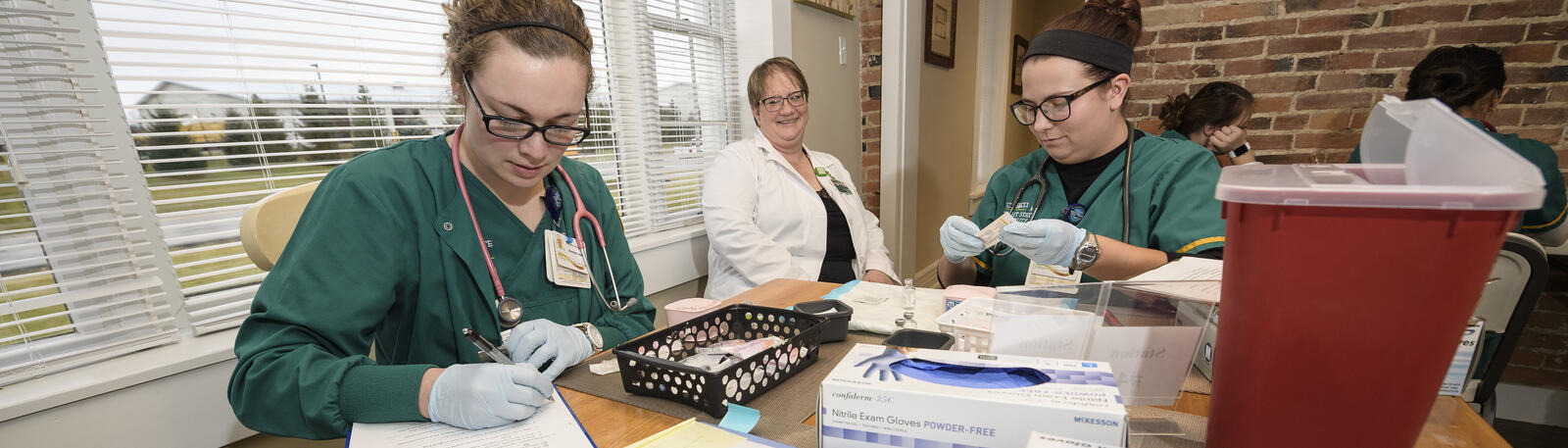 photo of nursing students and an instructor in a lab