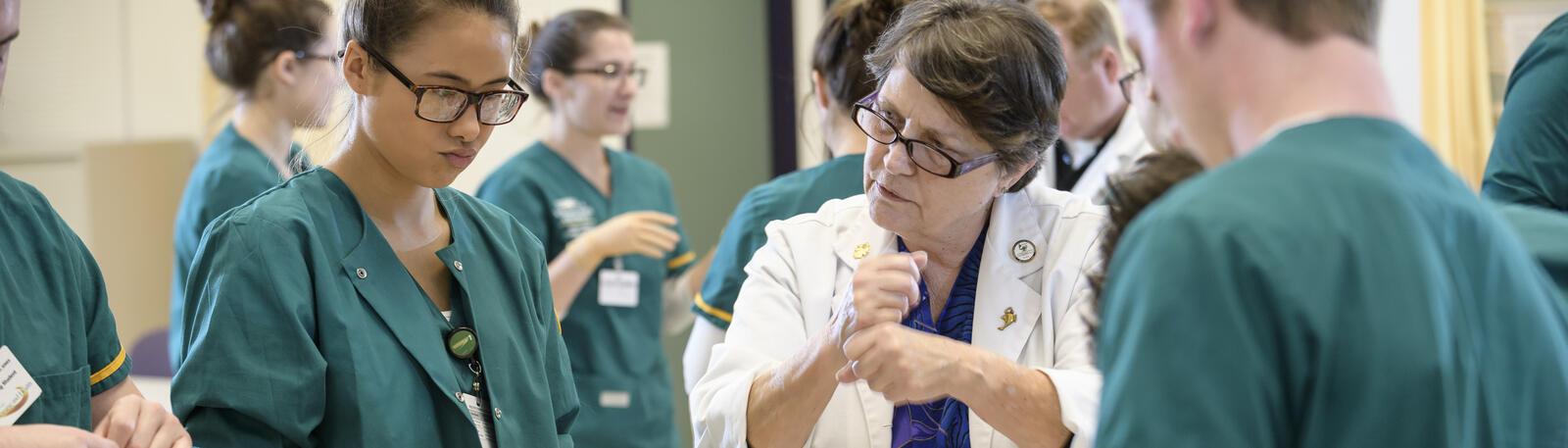 photo of nursing students and an instructor in a lab