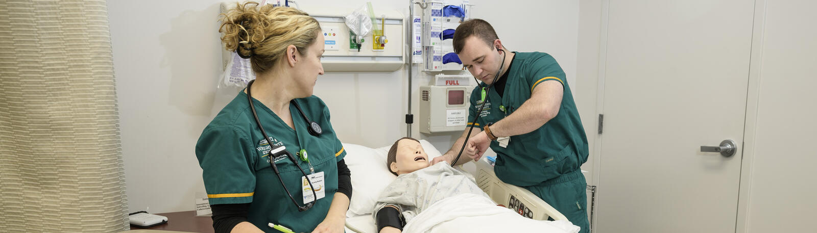 photo of two nursing students in a lab