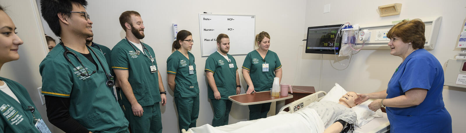 photo of nursing students and an instructor in a lab
