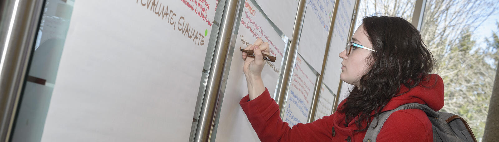 photo of a student writing on a flip chart