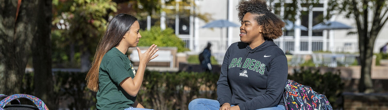 photo of students sitting outside on campus