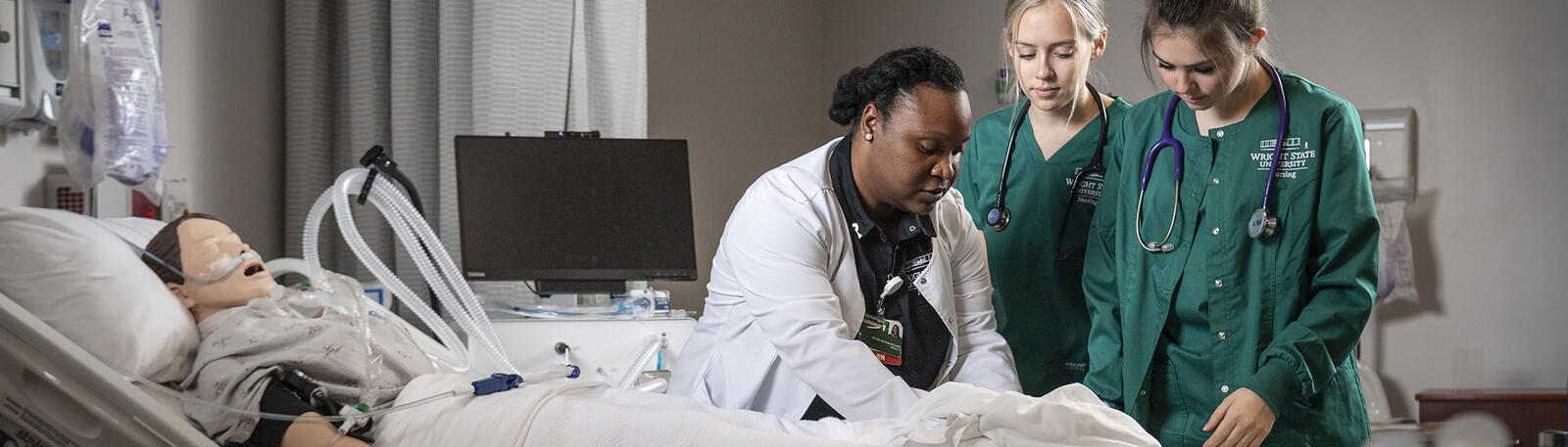 nursing students and an instructor working in a learning lab