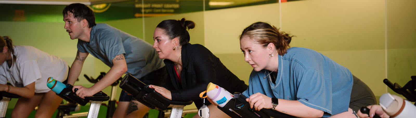students riding exercise bikes in a gym at wright state