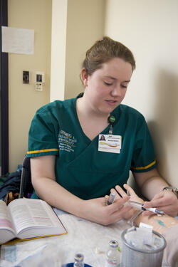 photo of a nursing student working in a lab