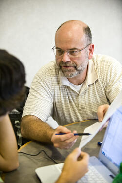 photo of a professor speaking to a student
