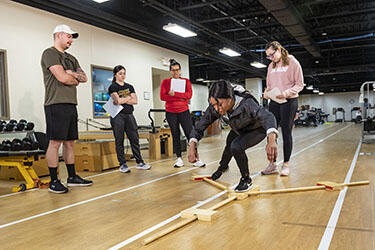 photo of students in a class in a gym