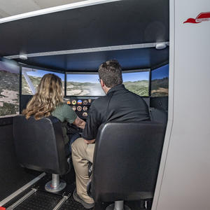 photo of a student and instructor in a flight simulator